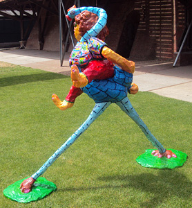 Polyester statue Ostrich Boy by Twan de Vos, boy riding an ostrich, to sit, he has his jersey on the neck of the ostrich done, garden statue